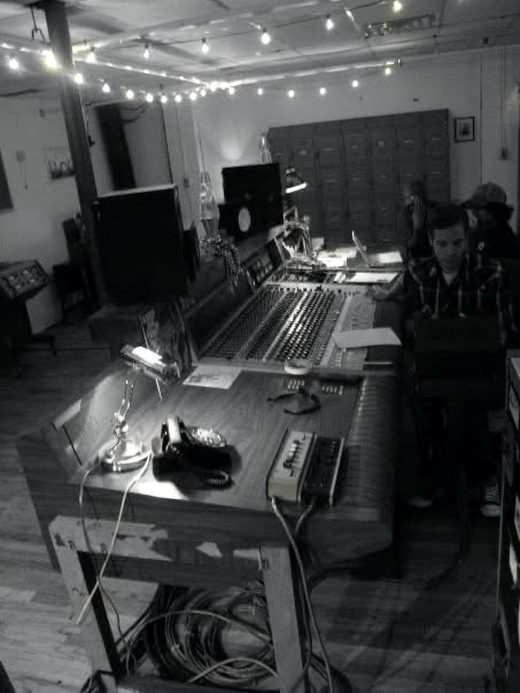 A recording studio control room at Welcome to 1979, an analog console at the center